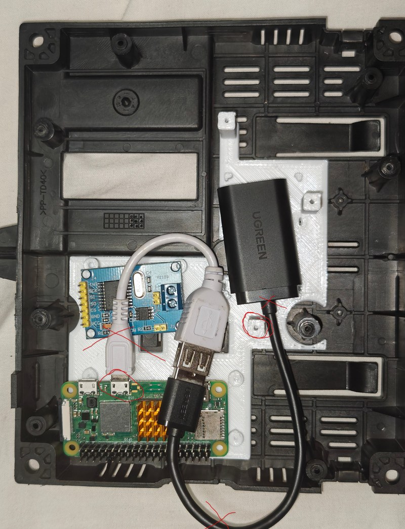 The first printed tray in the case with a Pi, the blue CAN module and the black USB sound card laid in, the adapter cable looping across the parts with red pen marks where it collides.